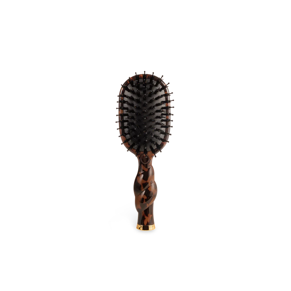 Hairbrush with tortoiseshell handle on a white background
